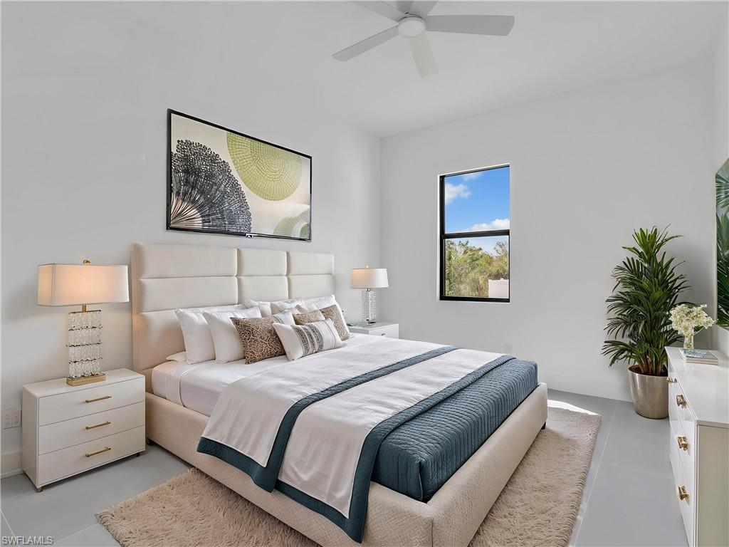 Bedroom with a ceiling fan and baseboards. This photo is virtually staged.