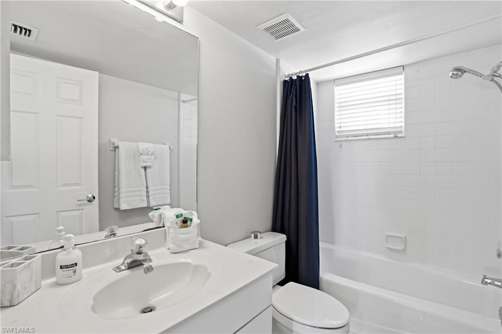 Bathroom with shower / tub combo and vanity
