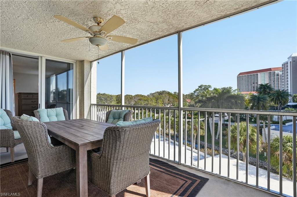 Sunroom / solarium featuring a balcony, outdoor dining area, and a ceiling fan
