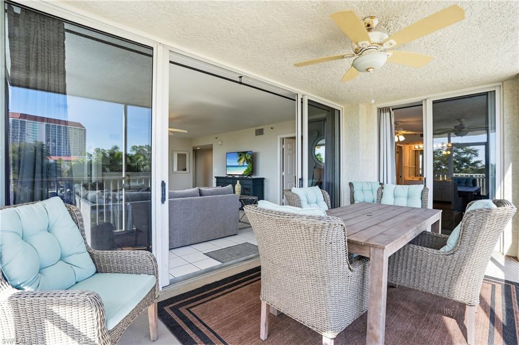 Sunroom with a ceiling fan and an outdoor living / dining area