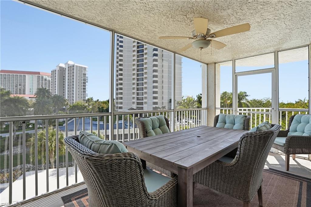 Sunroom / solarium with a ceiling fan, outdoor dining area, and a balcony
