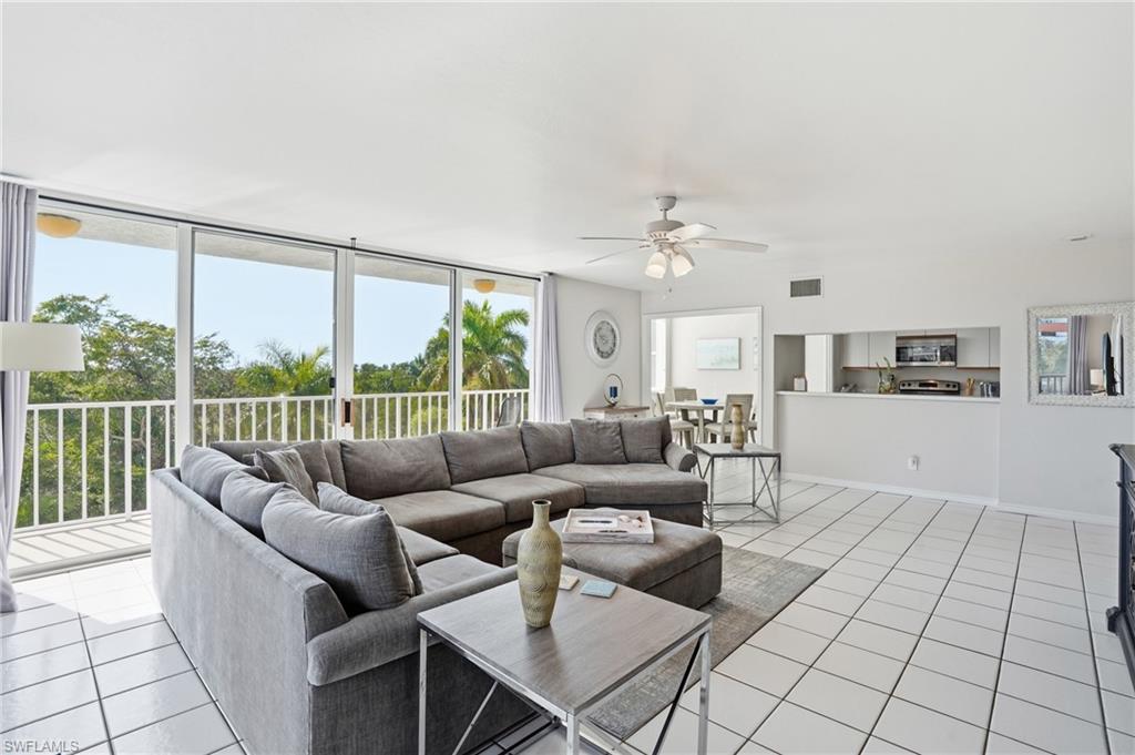Living room with ceiling fan and light tile patterned floors