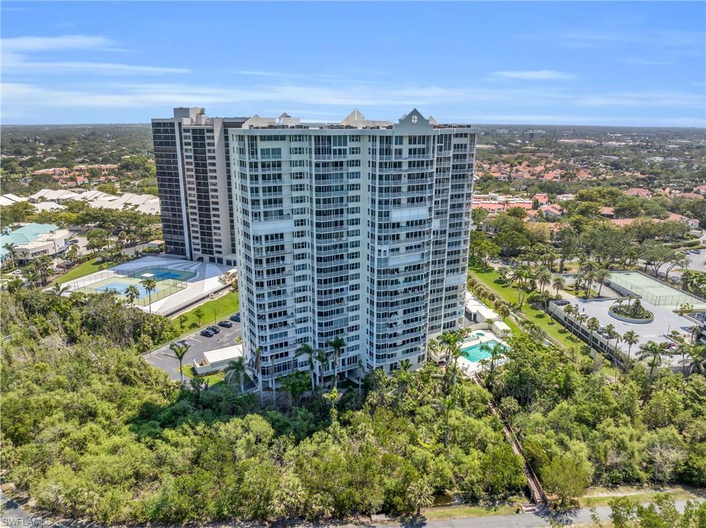 Drone / aerial view of apartment complex / building and a pool area