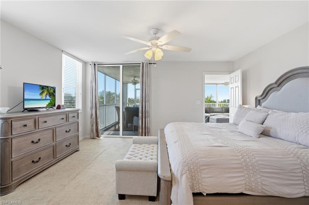 Bedroom with access to exterior, a ceiling fan, and light colored carpet
