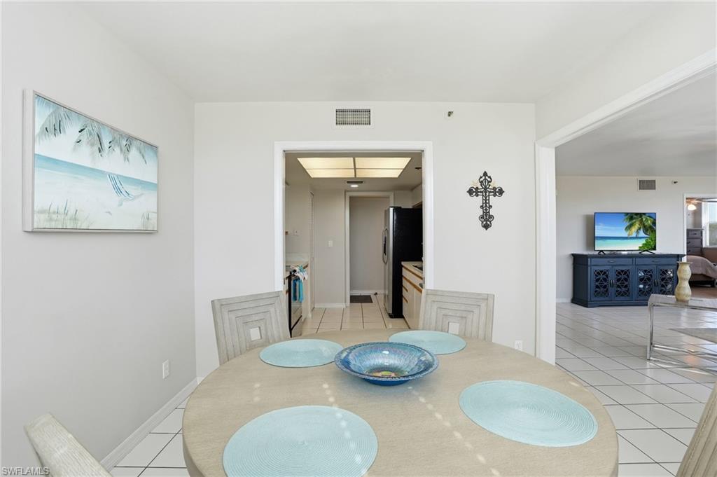 Dining space with light tile patterned floors