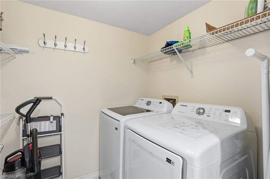 Laundry room with washer and dryer and baseboards