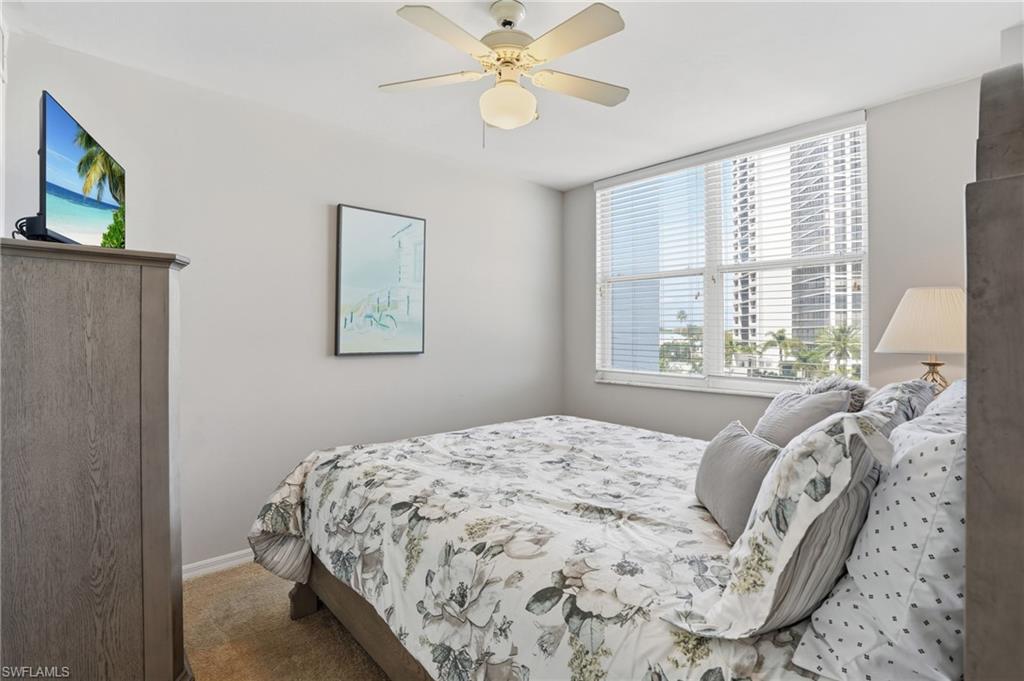 Bedroom with ceiling fan and carpet floors