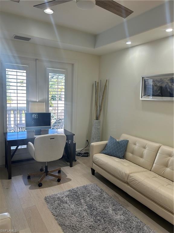 Den with french doors/custom plantation shutters leading to balcony