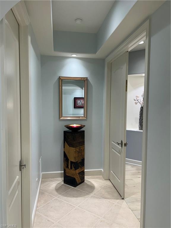 Corridor featuring recessed lighting and light tile patterned flooring