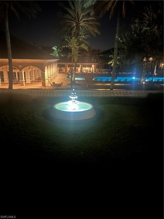 View of fountain and pool at night from lanai.