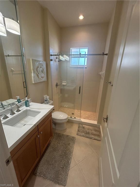 Bathroom with vanity, a shower stall, light tile patterned floors, and recessed lighting