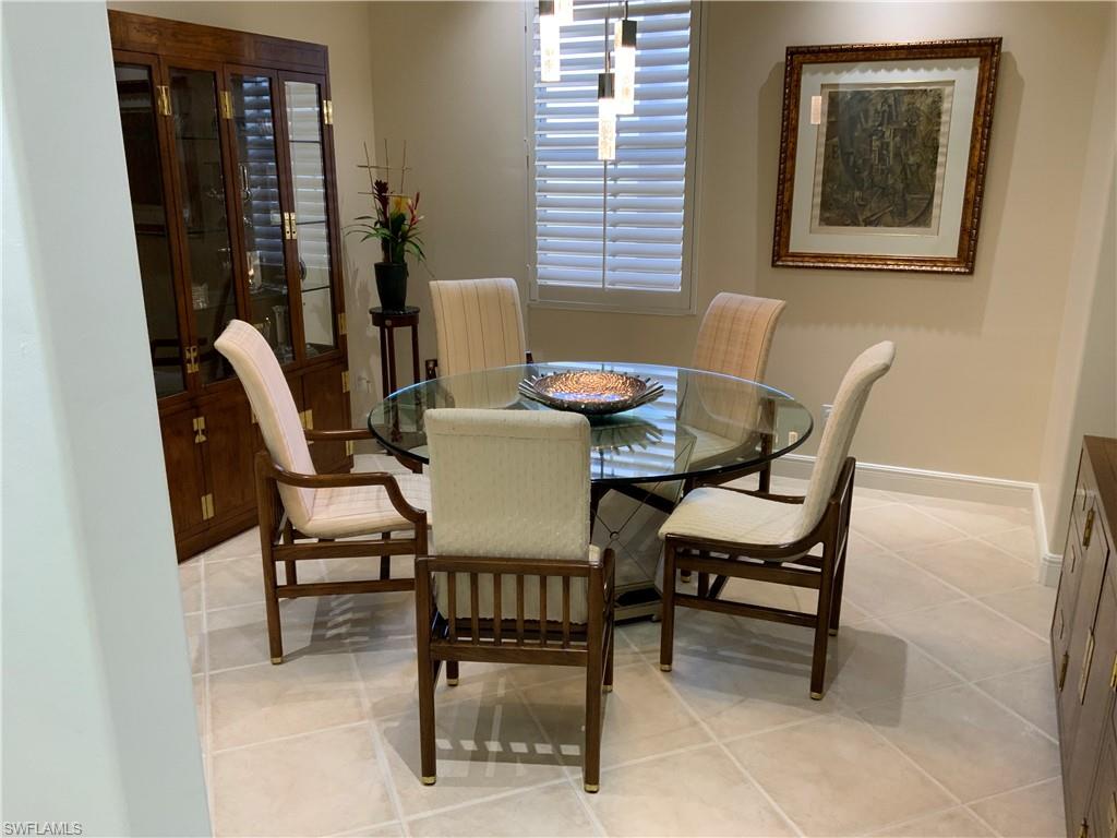 Dining room featuring light tile patterned floors and baseboards