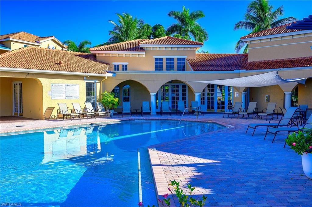 Community pool with a patio area and french doors