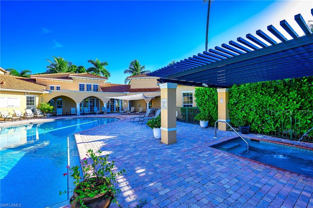 Community pool featuring a patio area, a pergola, and a community hot tub