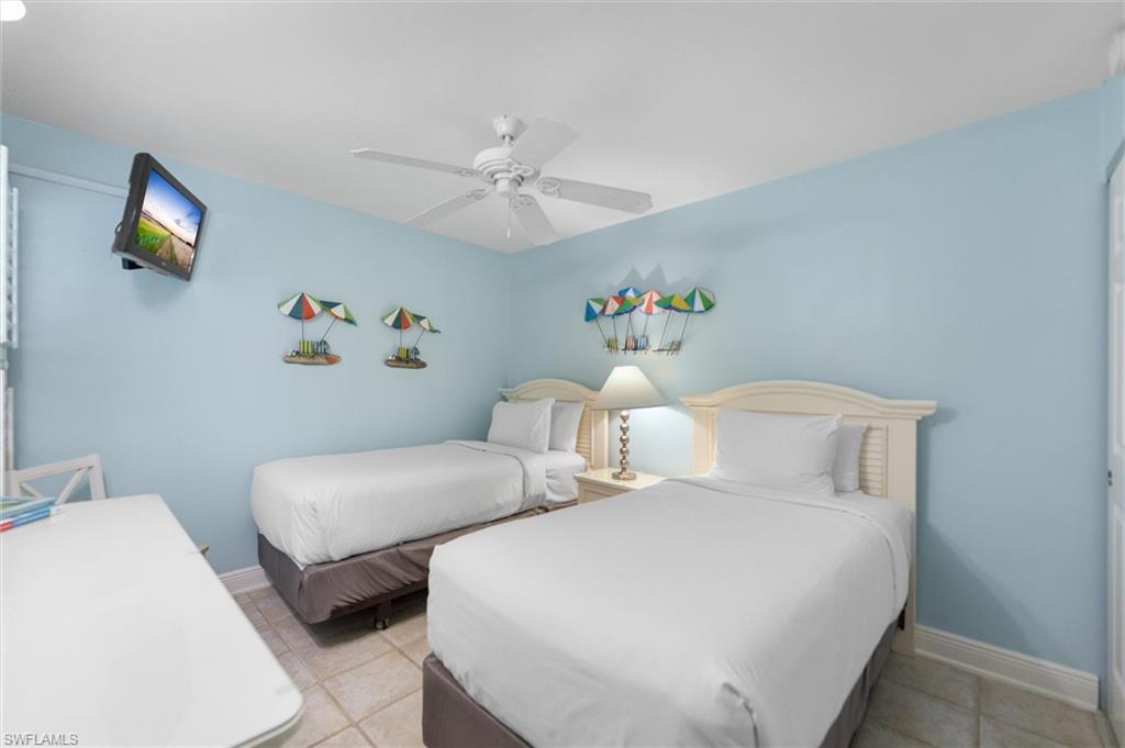 Bedroom with a ceiling fan and light tile patterned floors