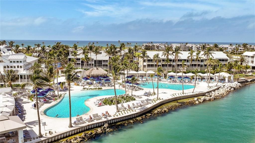 Community pool with a water view and a patio area