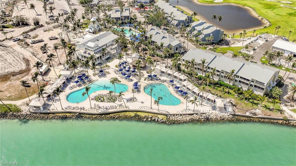 Bird's eye view of a pool area and a large body of water