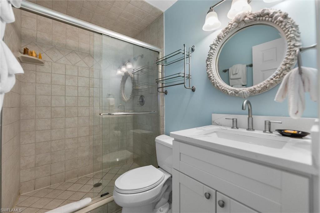 Bathroom featuring vanity and a stall shower