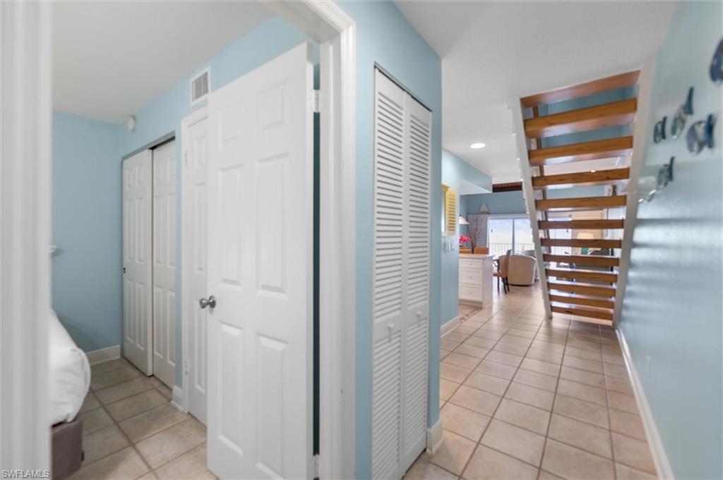 Hall featuring light tile patterned floors and recessed lighting
