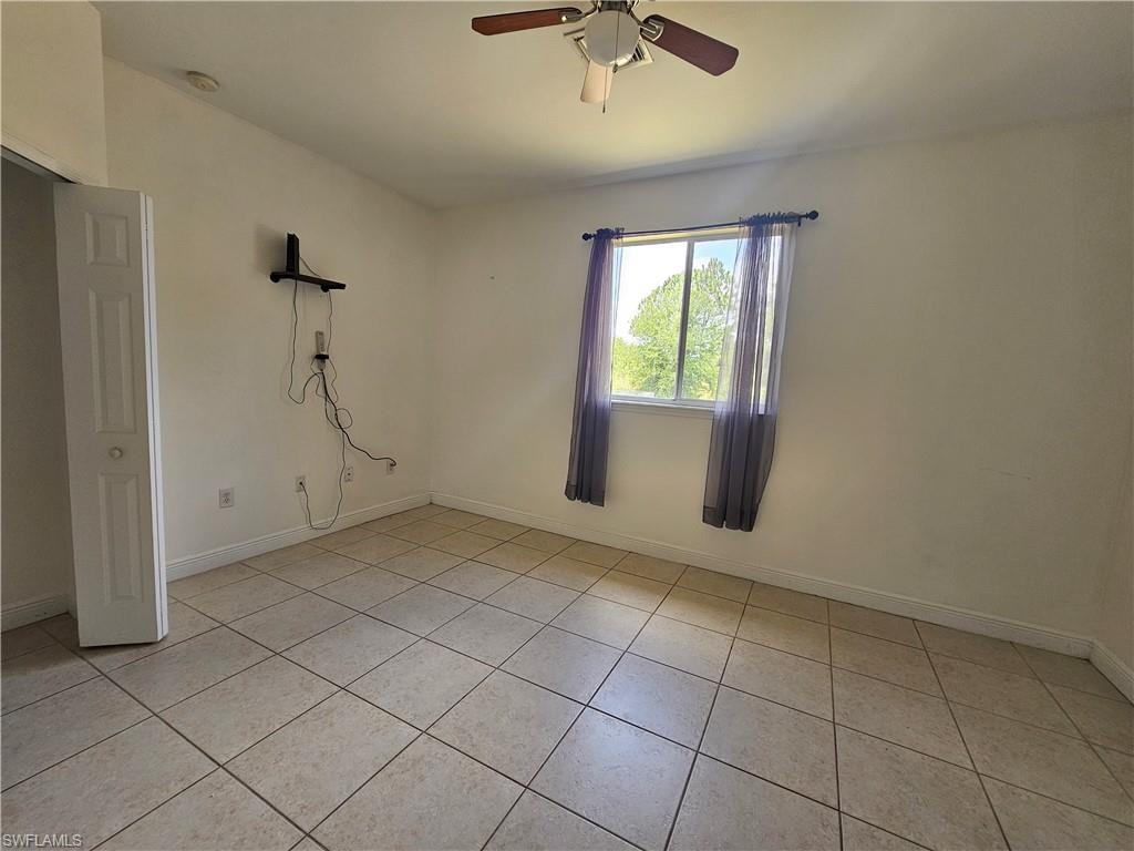 Full bathroom featuring shower / bath combination with glass door, tile flooring, oversized vanity, and toilet