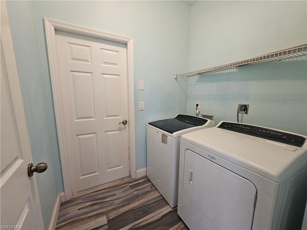 Walk in closet with wood-type flooring