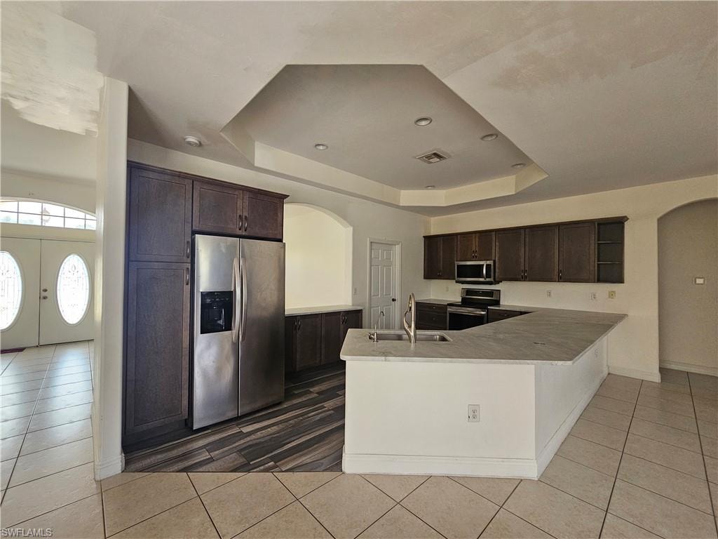 Hall featuring sink and light tile floors