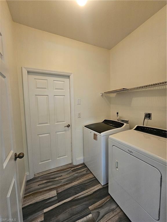 Dedicated laundry area featuring wood-finish flooring, light-colored walls, and a convenient wire shelf