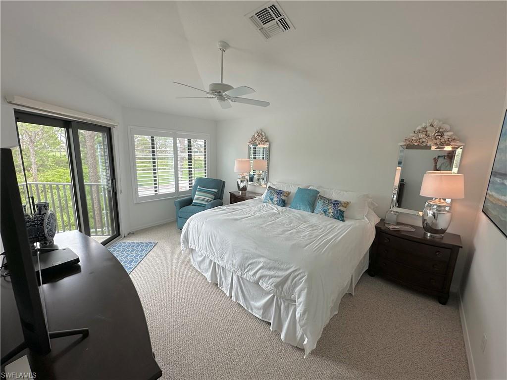 Bedroom featuring light carpet, access to outside, lofted ceiling, and ceiling fan