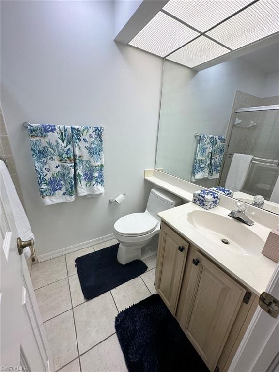 Bathroom with vanity, light tile patterned floors, and a shower stall