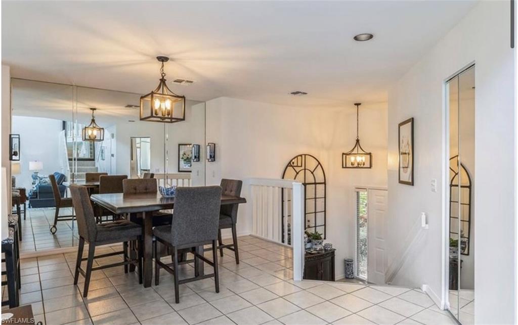 Dining area with a chandelier and light tile patterned floors