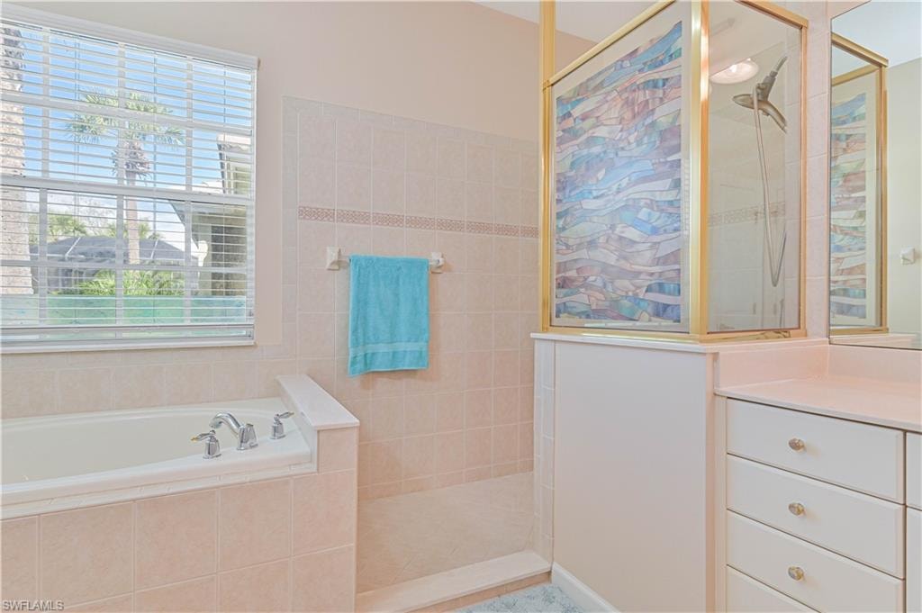 Full bathroom with a garden tub and walk in shower