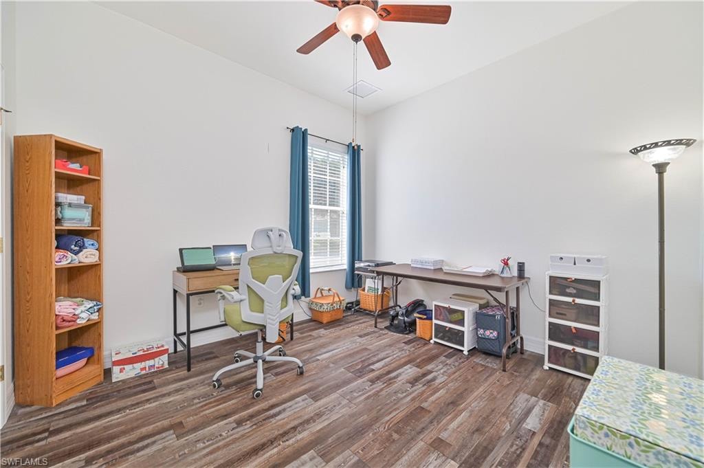 Office space featuring dark wood finished floors and a ceiling fan