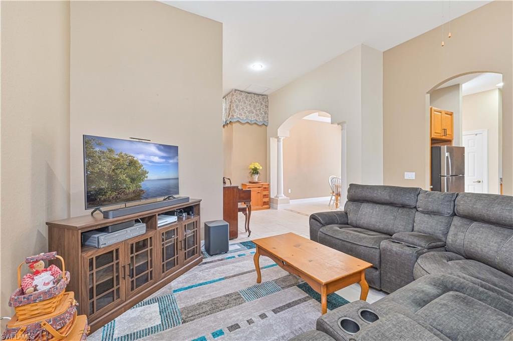 Living room featuring arched walkways and recessed lighting