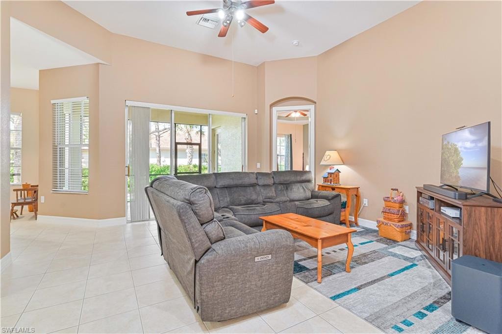Living area featuring a ceiling fan and light tile patterned floors