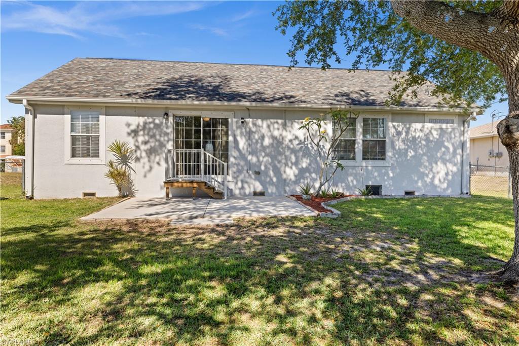 Back of property featuring a patio area and a shingled roof