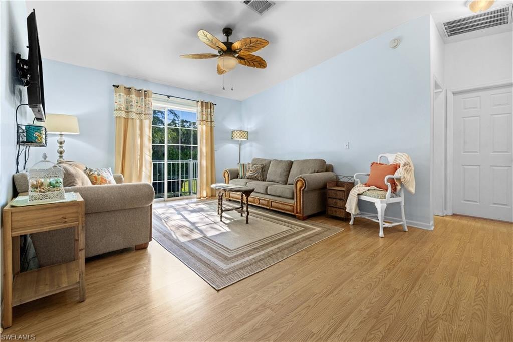 Living area featuring light wood-style flooring and a ceiling fan