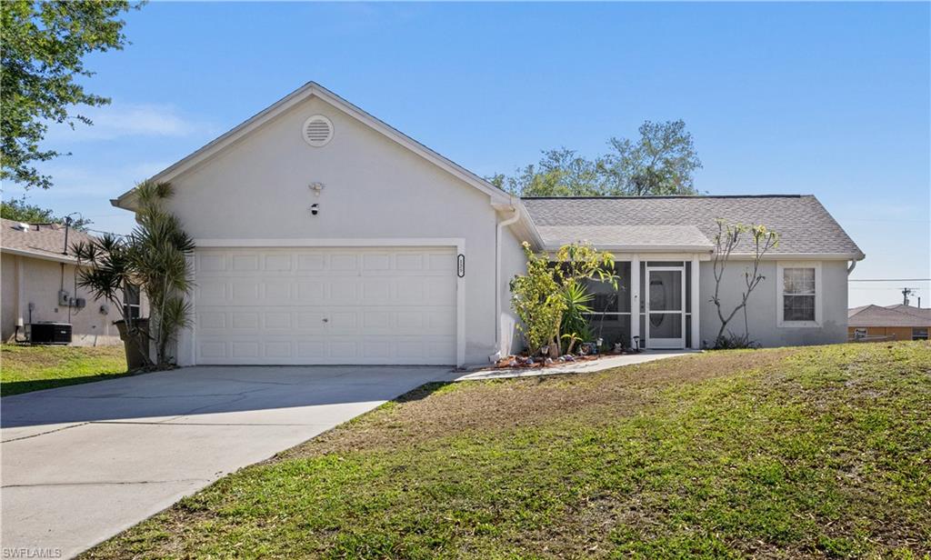 Single story home with stucco siding, a front lawn, concrete driveway, and a garage