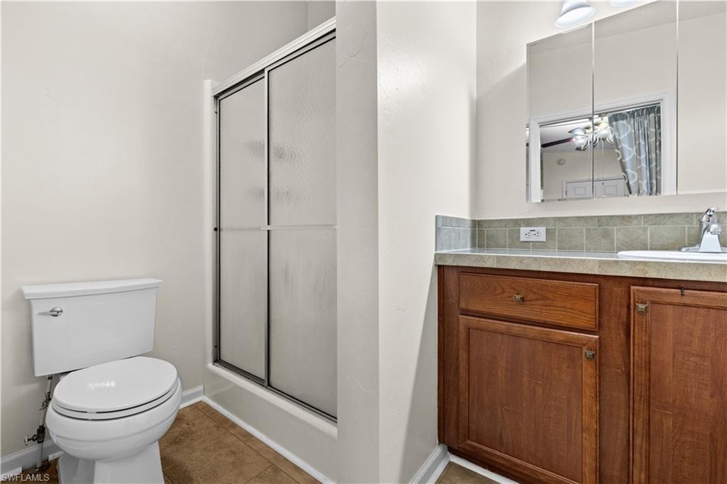Master Bathroom with a stall shower, vanity, and light tile patterned floors