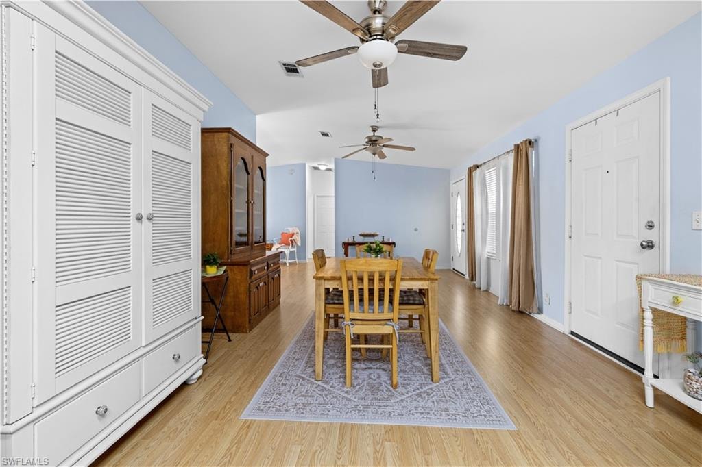 Dining room with ceiling fan and light wood finished floors