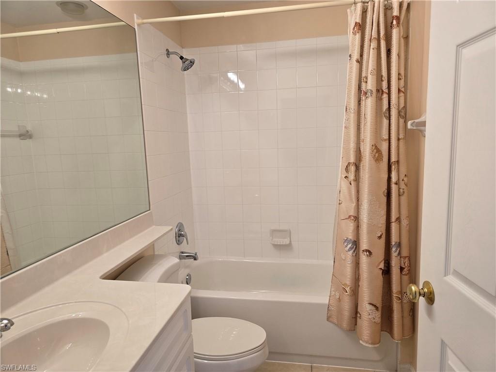 Bathroom featuring vanity and shower / bath combo with shower curtain