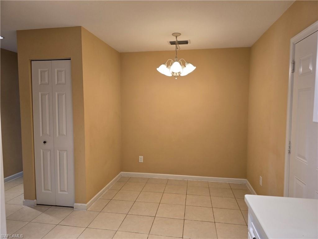 Breakfast area featuring hanging lights and light tile patterned floors