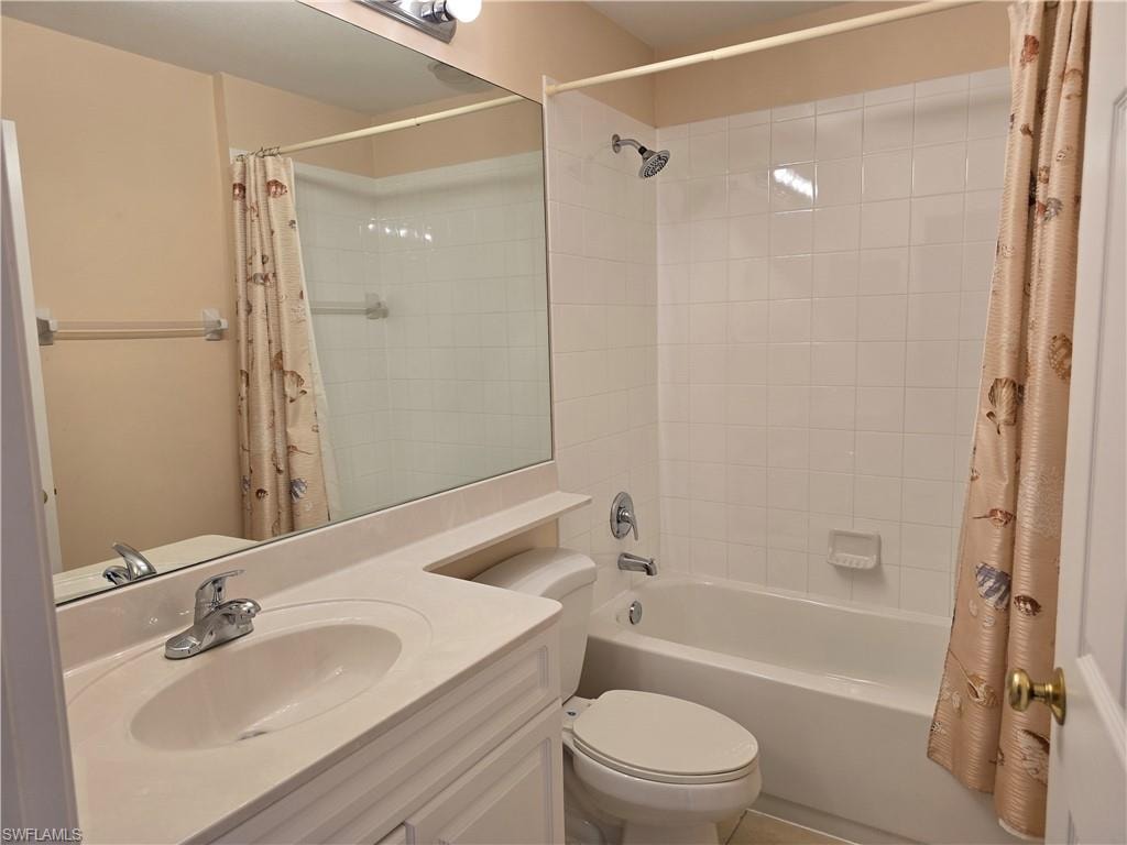 Full bath featuring vanity and shower / bathtub combination with curtain