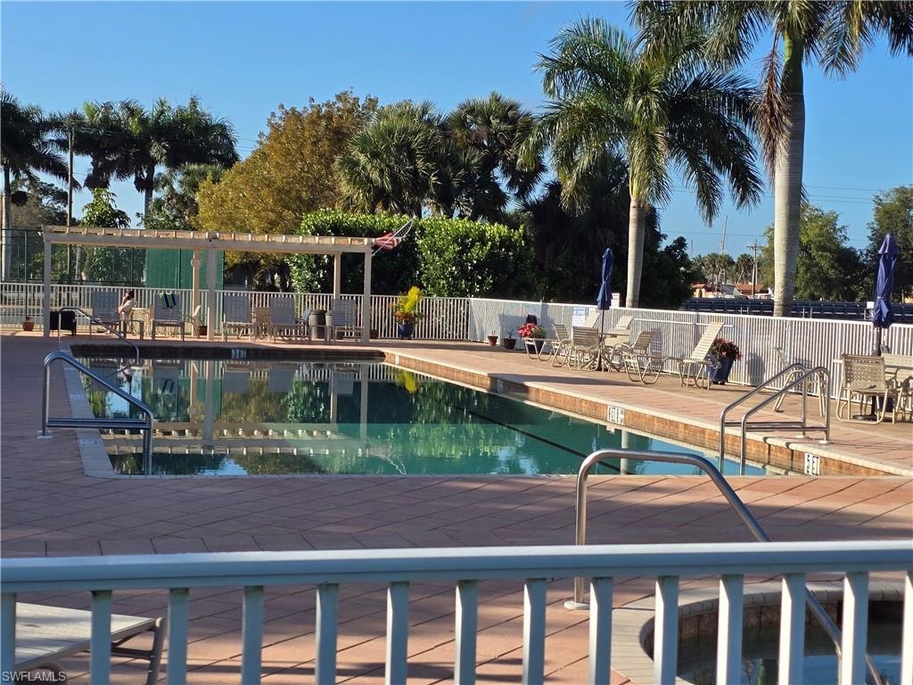 Community pool with a patio