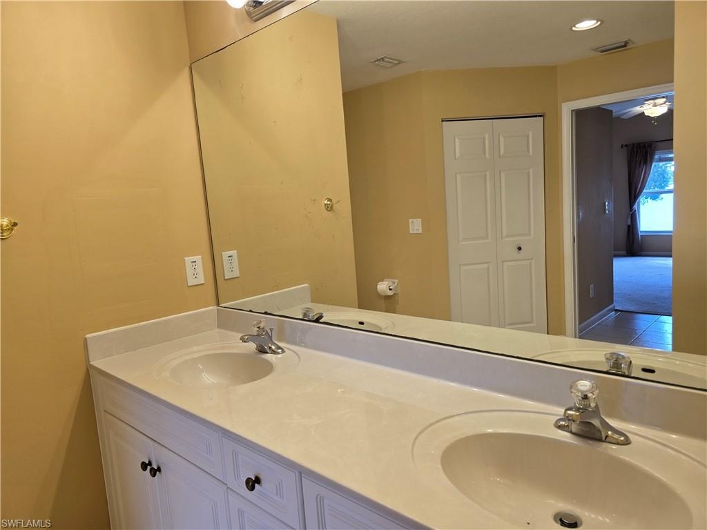 Master bathroom with a closet, double vanity, ceiling fan, and recessed lighting