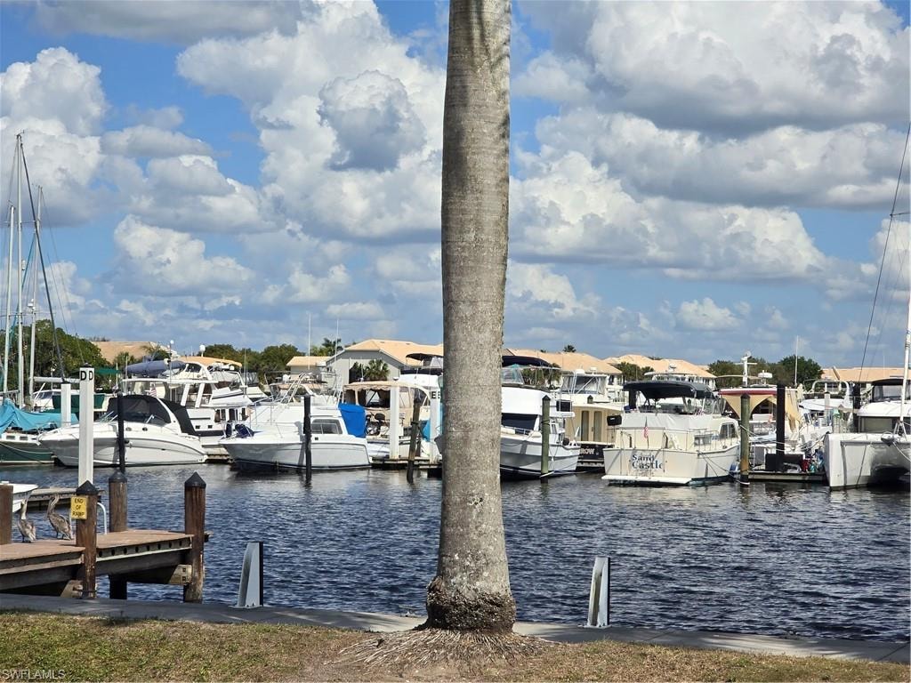 Dock area featuring boars & water view.