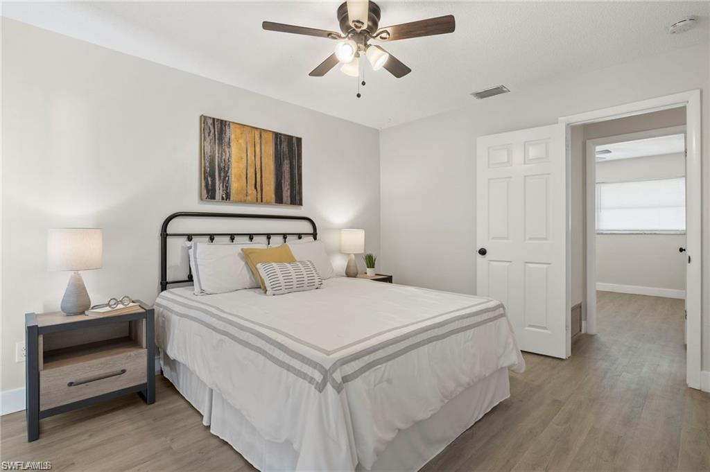 Bedroom with light wood-style flooring and a ceiling fan