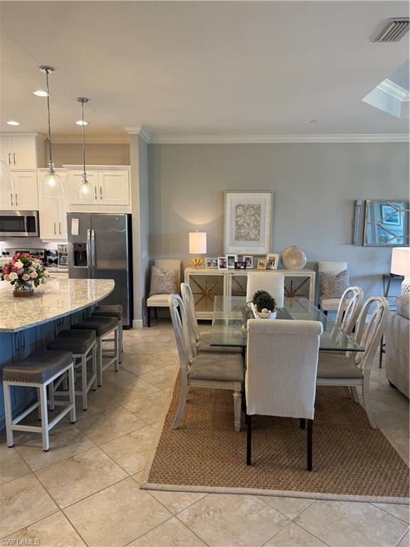 Dining space featuring crown molding and recessed lighting