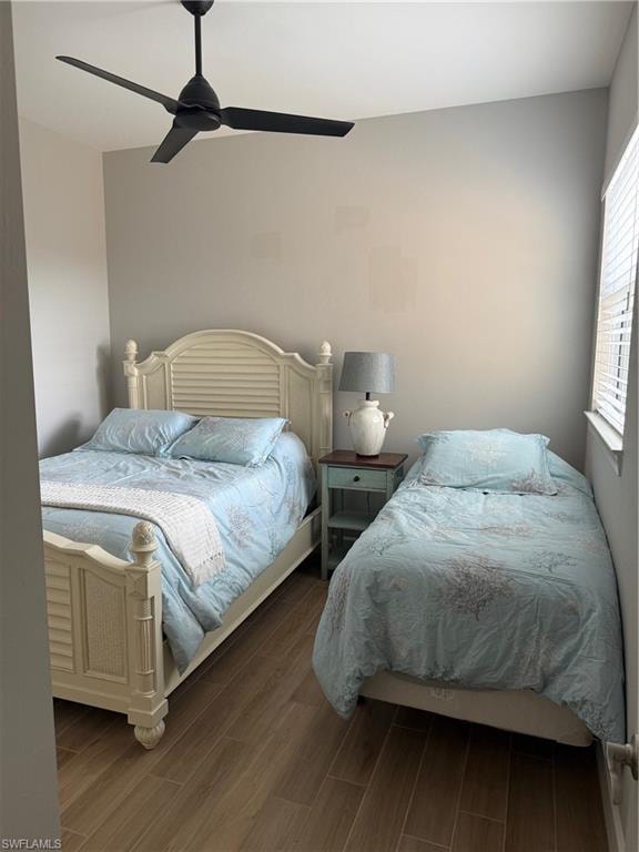 Bedroom featuring wood tiled floors and a ceiling fan