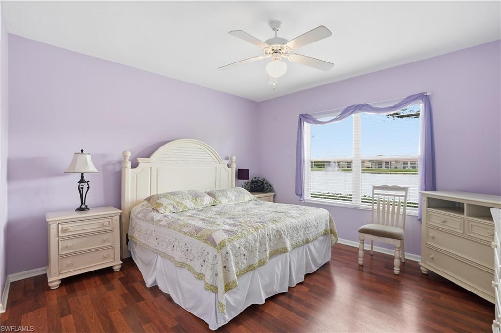 Bedroom with dark wood-style floors and a ceiling fan