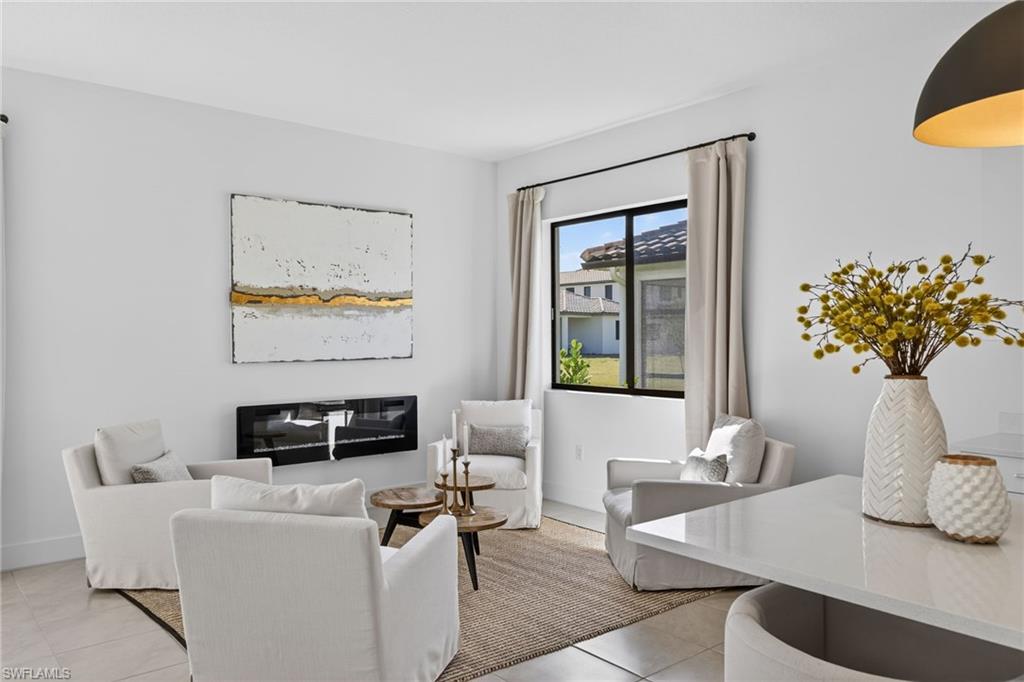 Living room with light tile patterned floors and baseboards